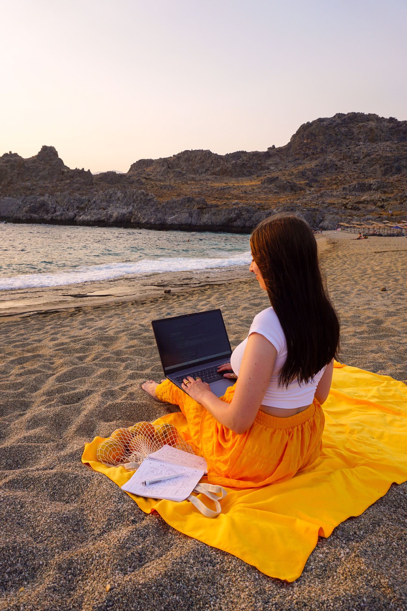 Anki working on her laptop at the beach